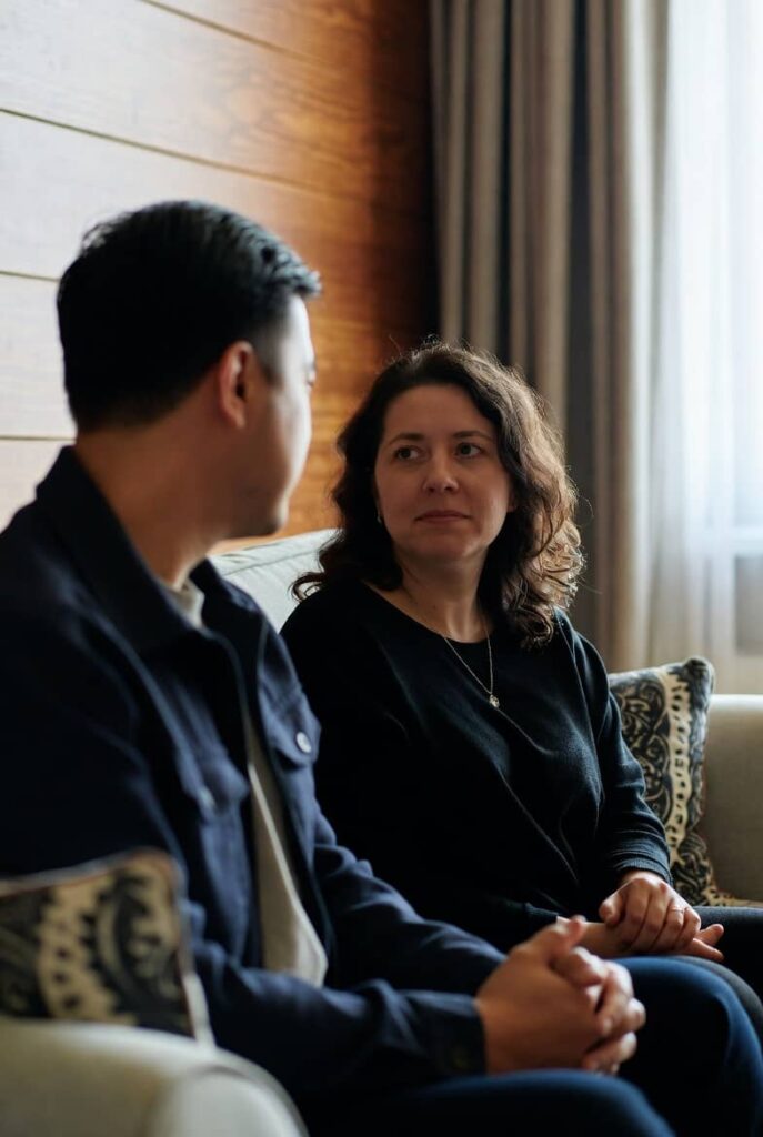 Couple in counselling session discussing affair recovery in Hampstead therapy room