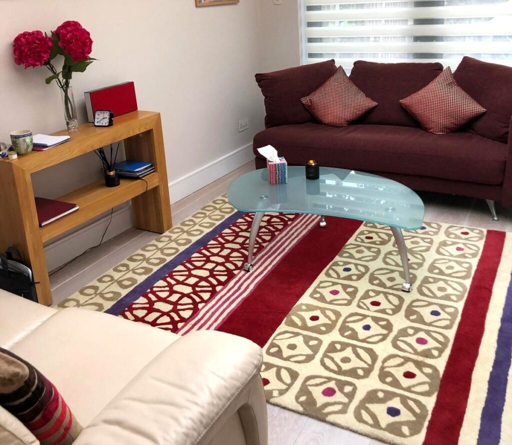 Counselling room with a sofa, patterned rug and coffee table